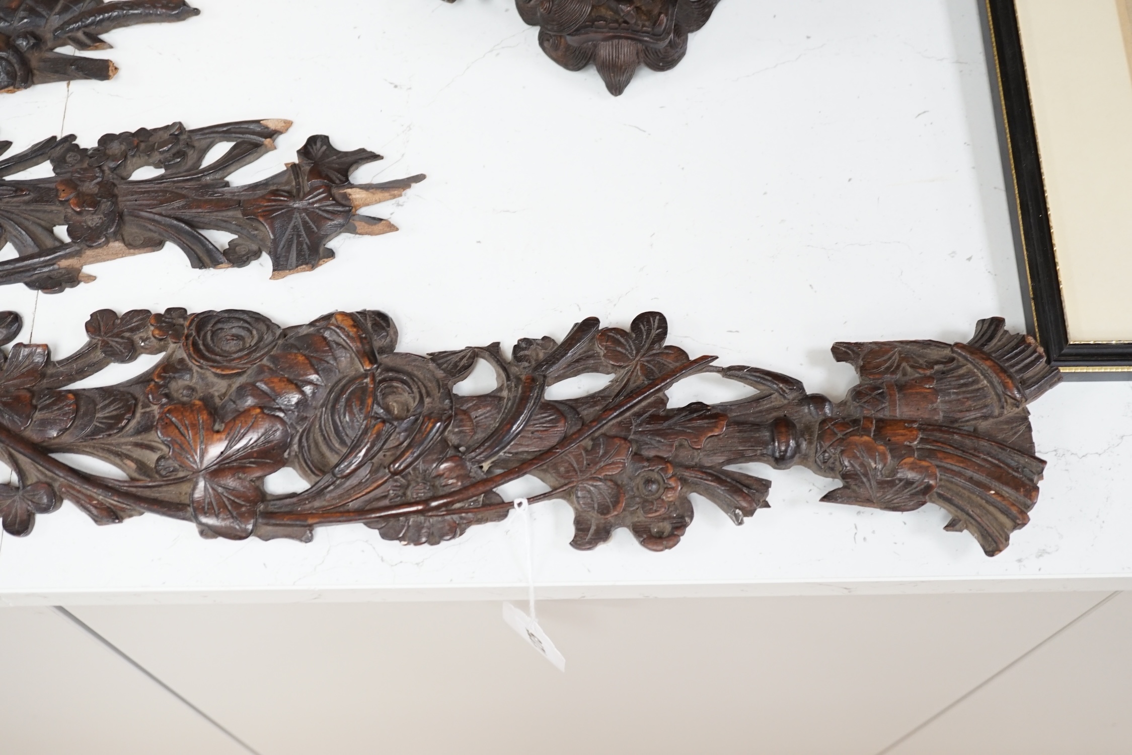 A carved walnut frieze and section with floral decoration, 131cm long. Condition - poor to fair, broken into sections and some woodworm